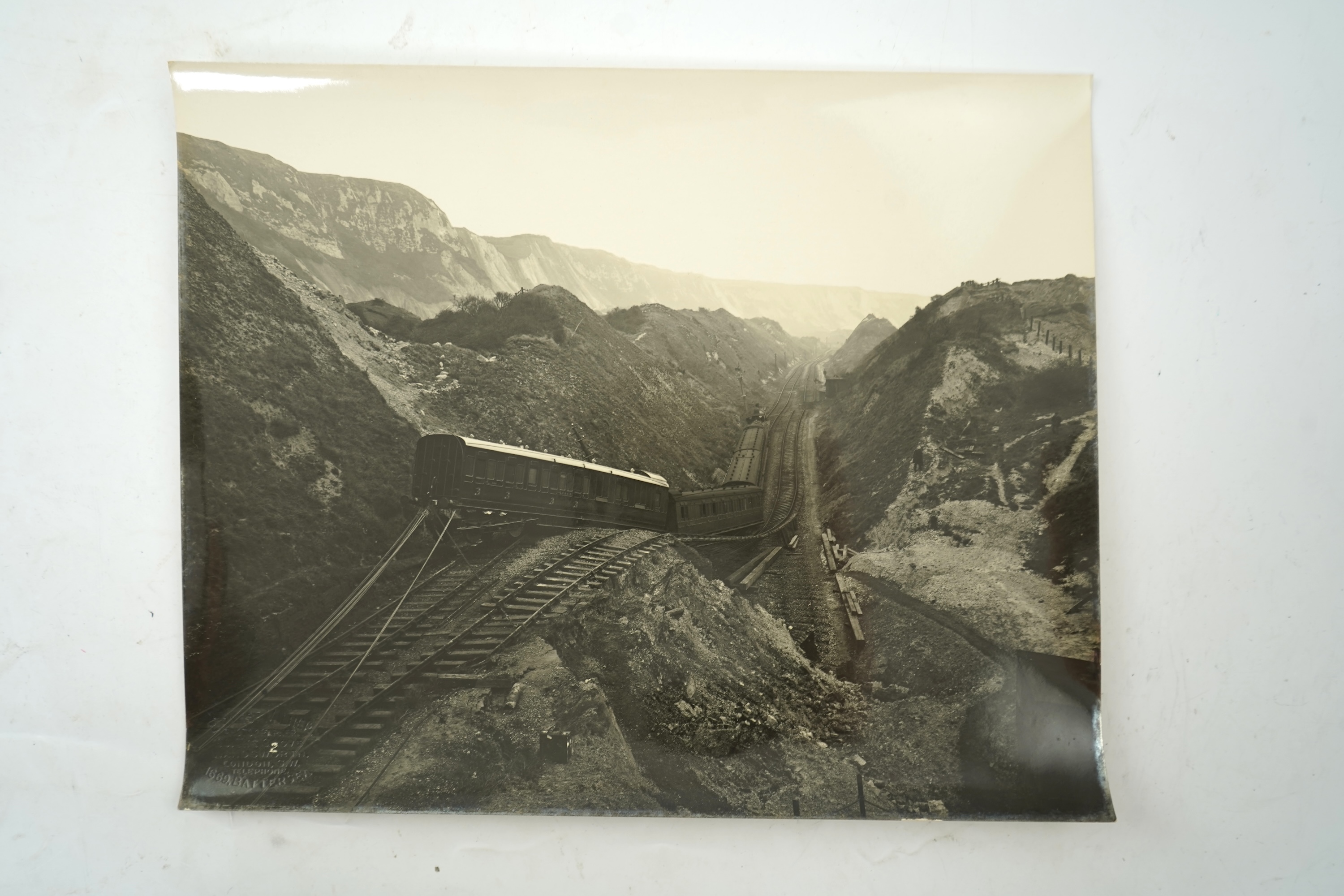 Fourteen late 19th/early 20th century black and white photographs of the results of a chalk landslide on the SE&CR, South East and Chatham Railway, at East Wear Bay, Capel-le-Ferne, Kent, with annotations to the reverse